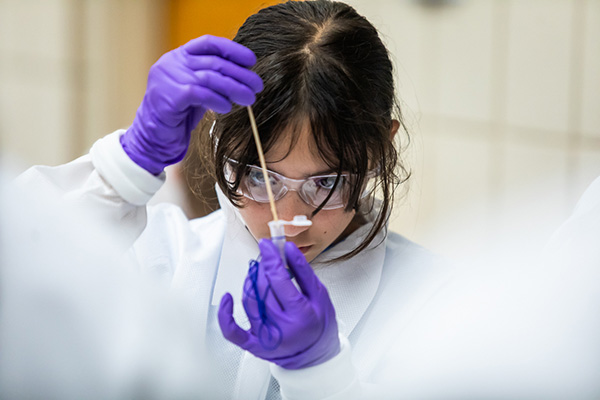 student-purple-gloves-testing